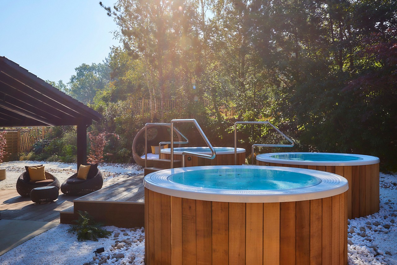 Bubbling outdoor hot tubs surrounded by the forest.